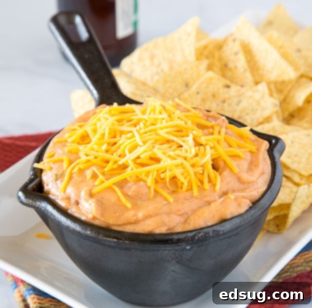 Kickoff Comfort Food 19 Easy Refried Bean Dip, creamy and cheesy, garnished with fresh herbs