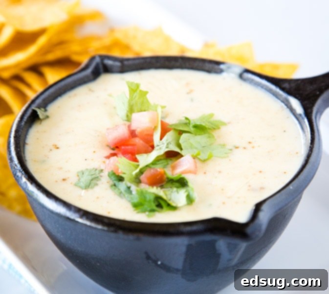 Kickoff Comfort Food 20 Mexican White Queso Dip, creamy and spicy, served in a bowl with chips