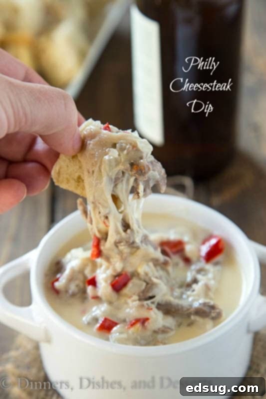 Kickoff Comfort Food 22 Philly Cheesesteak Dip, bubbling hot with tender steak, peppers, and onions