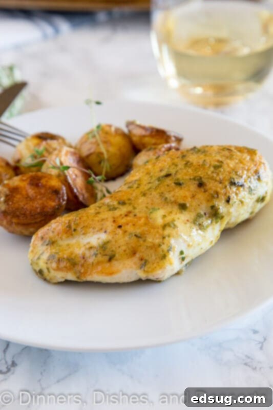 One-Pan Chicken and Potatoes 5 Sheet pan chicken and roasted potatoes on a plate with fresh herbs