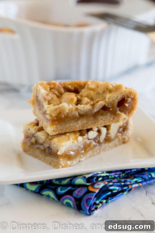 a close up of salted caramel crumble bars, highlighting the layers