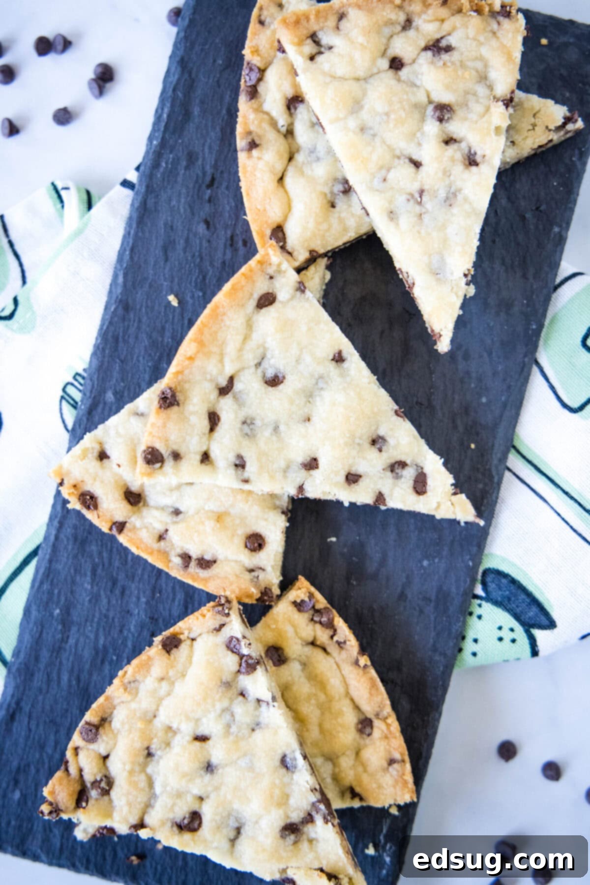 Overhead view of eight pieces of chocolate chip shortbread cut into triangles.
