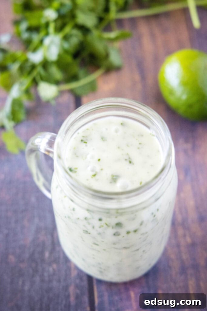 A sealed jar of homemade cilantro lime salad dressing, ready for storage.
