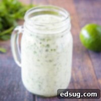 Close-up of a jar with vibrant green cilantro lime dressing