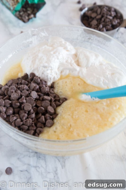 Foolproof Microwave Fudge 3 ingredients in a bowl with a spatula, ready to be mixed