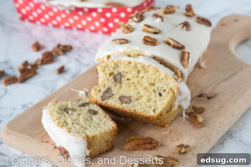 Maple Pecan Dream Loaf 3 Two maple pecan loaves, one whole and one sliced, showcasing the tender crumb and pecan pieces, topped with maple glaze.