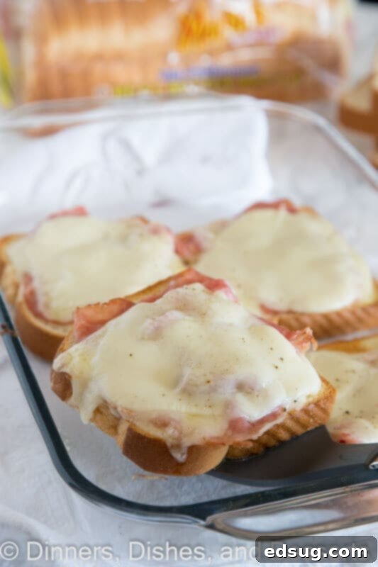 Uncovered Croque Monsieur 4 Several open-faced croque monsieur sandwiches plated, showing the golden-brown crust and melted cheese from a different angle.