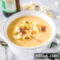 Cropped image of a rich beer cheese soup in a bowl.