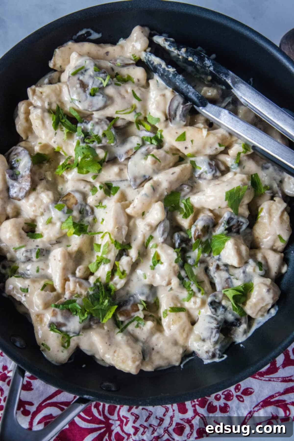 Velvety Chicken Stroganoff 5 Looking down on a skillet full of creamy chicken stroganoff, rich with chicken, mushrooms, and sauce, ready to be served