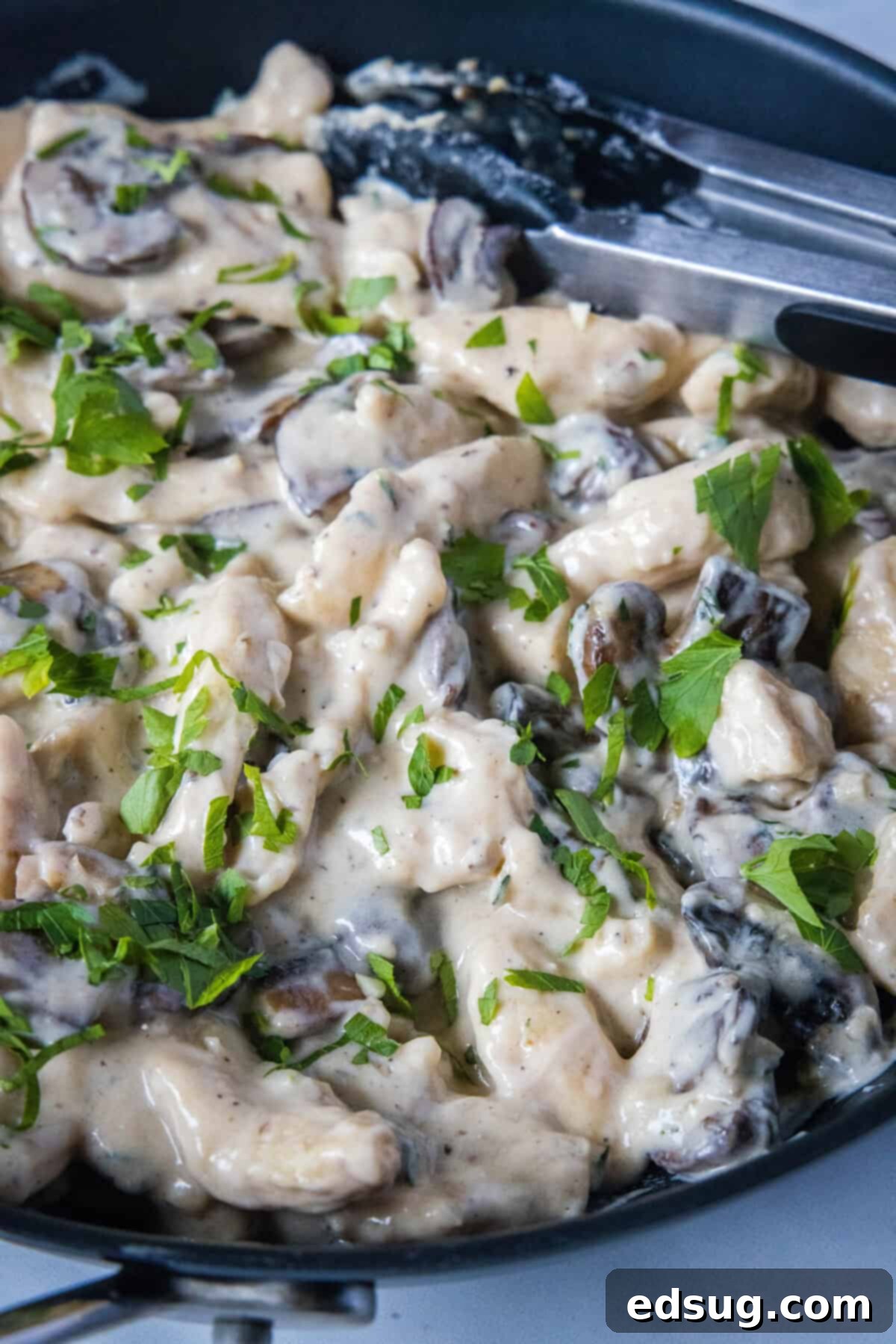 Velvety Chicken Stroganoff 7 Creamy Chicken Stroganoff bubbling gently in a large skillet, showcasing the rich sauce and tender ingredients