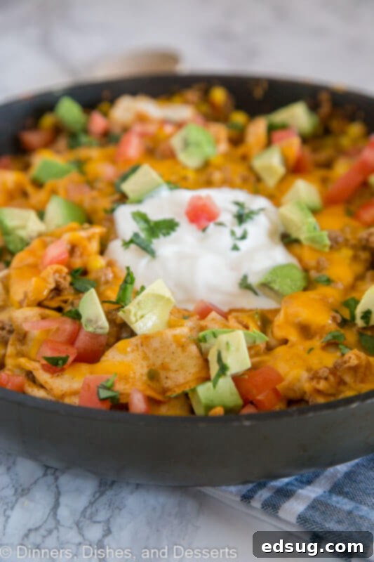 A pan filled with a hearty Beef Burrito Skillet, rich with beef, corn, and tortillas