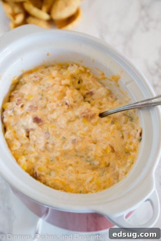 Creamy Cheesy Corn Dip 3 Close-up of creamy cheesy corn dip in a slow cooker, ready to be served.