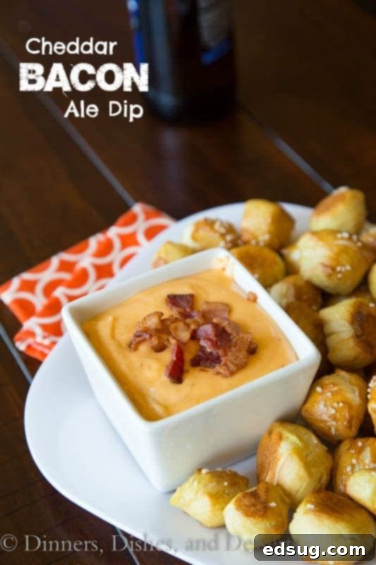 Rich & Creamy Beer Cheese Dip 2 beer cheese dip in a bowl with pretzel bites