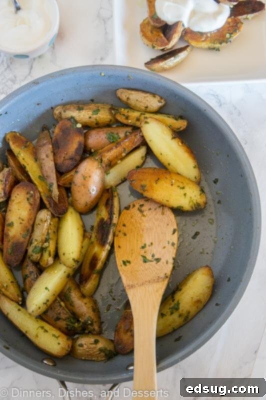 A large serving bowl filled with Pan-Seared Mojo Potatoes, garnished with fresh herbs, ready to be enjoyed as a family-friendly side dish at the dinner table.