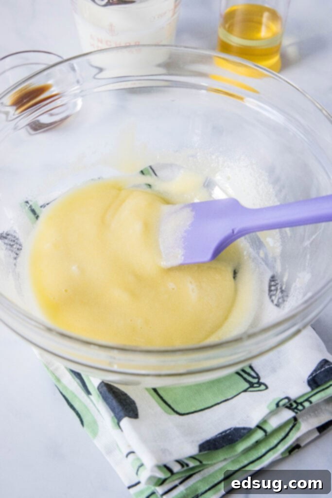 Cinnamon Swirl Muffins 4 mixing eggs and sugar together in a large mixing bowl