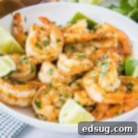 27 Effortless Shrimp Meals 4 Close up of a white bowl filled with vibrant cilantro lime shrimp.