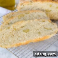 A piece of bread on a plate, with Olive