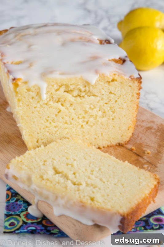 Sunshine Lemon Ricotta Loaf 4 Three slices of perfectly baked lemon ricotta pound cake on a cutting board, each slice adorned with a generous drizzle of lemon glaze, ready to be enjoyed.