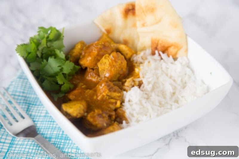 Creamy Coconut Chicken Curry 3 A plate full of food, with chicken Curry and rice