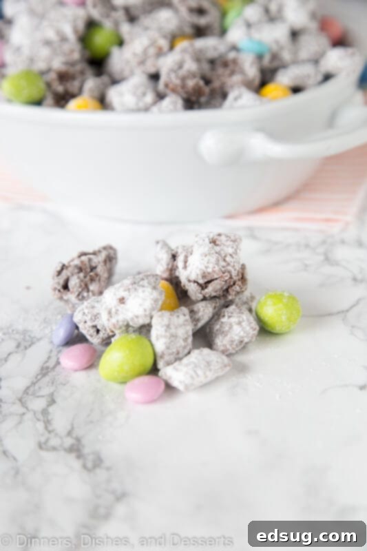 Easter Bunny Chow 3 Easter Muddy Buddies with colorful candy spread on a table, ready to serve