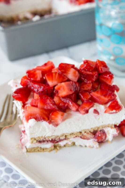 Sweet Layers of Strawberry Cheesecake Bliss 4 A serving of strawberry cheesecake lasagna garnished with fresh whole strawberries and mint