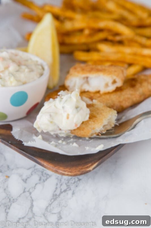 The Secret to Red Lobster's Iconic Tartar Sauce 5 bite of fish with tarter on a plate