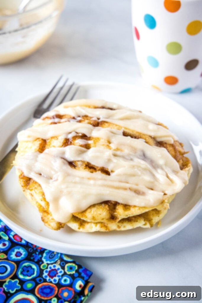 Cinnamon Swirl Pancakes 2 stack of pancakes topped with cream cheese glaze