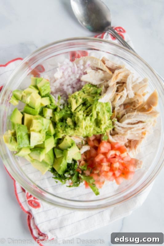 Creamy Avocado Chicken Salad 3 All the ingredients for No Mayo Avocado Chicken Salad in a bowl, ready for mixing.