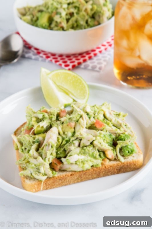 Creamy Avocado Chicken Salad 4 Close-up of a vibrant No Mayo Chicken Salad with avocado, fresh tomatoes, and red onion.