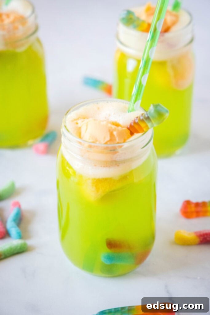 Cauldron's Whisper 4 green drink with orange sherbert in a glass