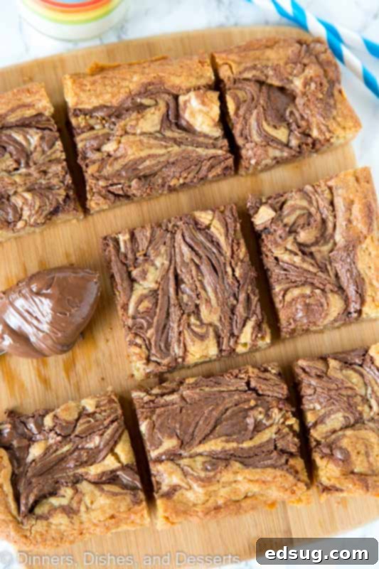 Blondies swirled with nutella on a cutting board