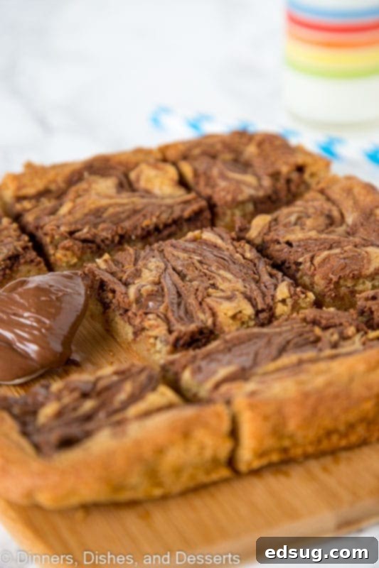 Blondies swirled with nutella on a cutting board