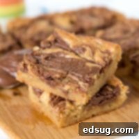 Nutella Swirl Blondies - Quick and easy blondies made in one bowl with a swirl of Nutella. All that buttery and brown sugar taste you love with an extra touch of chocolate.
