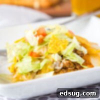 A plate of taco pizza ready to be enjoyed, showcasing crispy crust and fresh toppings