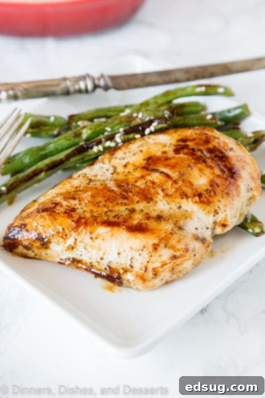 A plate of golden-brown Honey Dijon Chicken, garnished and ready to serve.