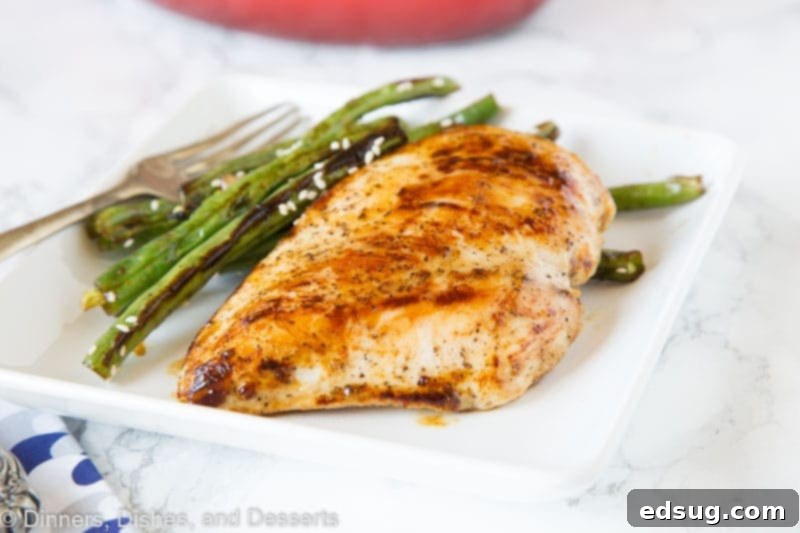 A close-up of raw chicken cutlets coated in the honey dijon marinade, ready for cooking.