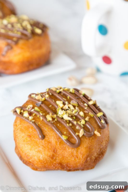 A freshly fried Nutella donut on a white plate, ready to be enjoyed.