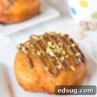 Nutella Donuts Recipe - make your own donuts at home using biscuits! They fry up quickly and are super easy. Filled with Nutella and topped with chopped pistachios.