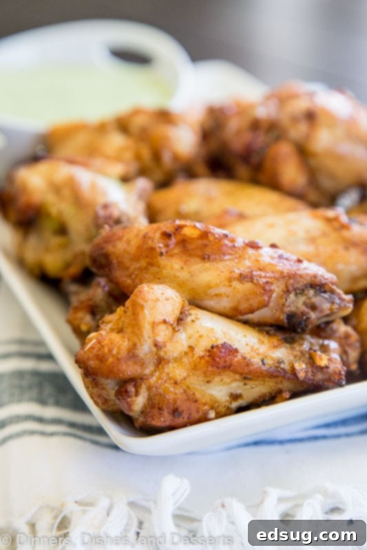 Green Goddess Baked Chicken Wings 5 Baked chicken wings piled high on a plate, ready to be served