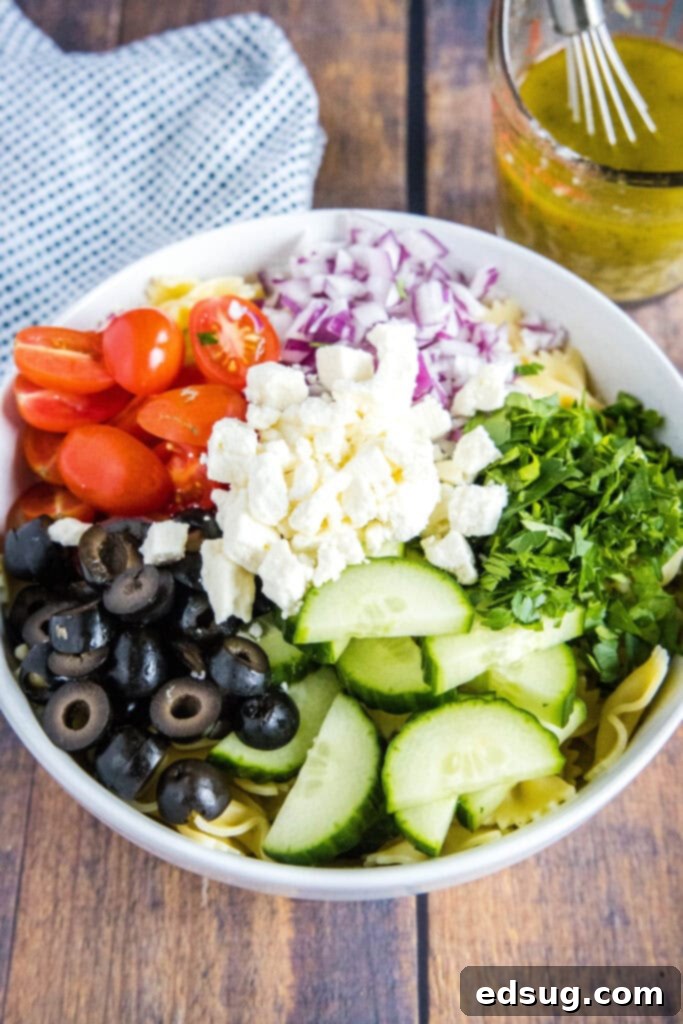 Zesty Greek Pasta Salad 3 toppings for greek pasta salad arranged in a bowl
