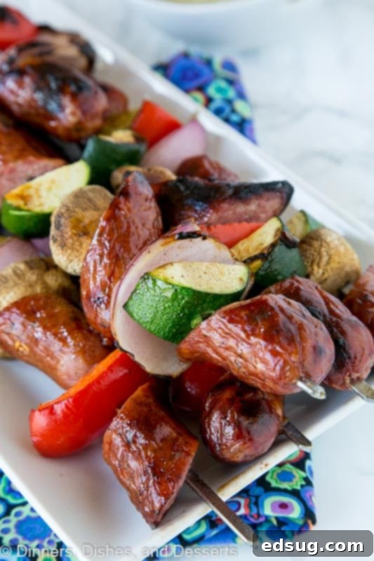 Sizzling Sausage and Veggie Kebabs 5 grilled sausage and veggie kebabs on a plate