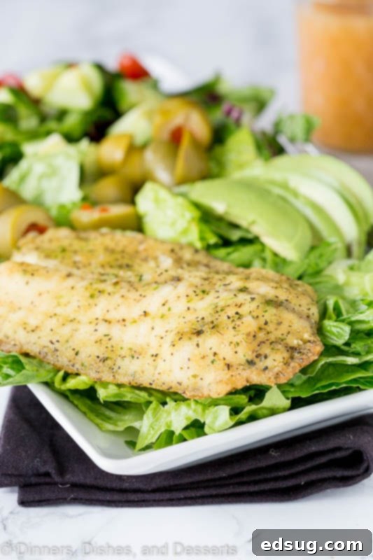 Mediterranean Garlic Herb Salad 6 Garlic & herb Mediterranean salad on a plate with grilled fish, ready to be served