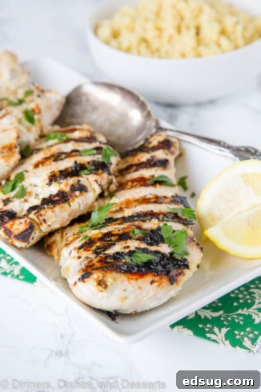 Perfectly Tender Yogurt Chicken 4 A delicious plate of yogurt marinated grilled chicken served with fresh lemon slices.