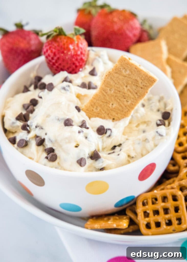 cookie dough dip with a pretzel and a strawberry being dipped
