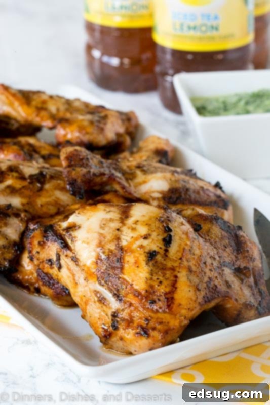 Chargrilled Chicken Thighs 3 Close-up shot of grilled chicken thighs resting on a platter, showcasing their golden-brown char and juicy appearance.