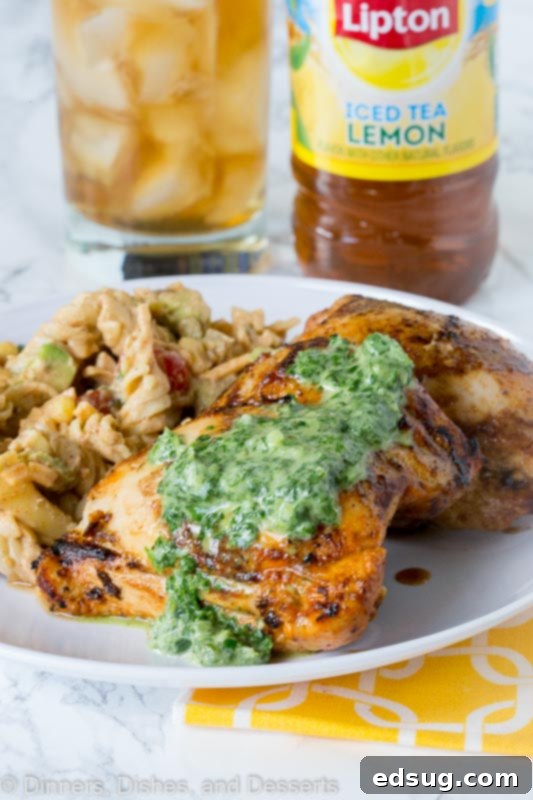 Chargrilled Chicken Thighs 4 A beautifully plated dish featuring grilled chicken thighs, drizzled with the vibrant green chile herb sauce and garnished with fresh herbs.