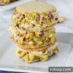 Pistachio ice cream sandwiches in a stack, showcasing the homemade creamy filling and cookie texture