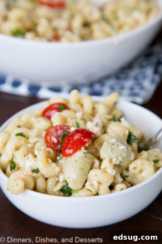 Sun-Kissed Mediterranean Pasta Salad 2 A vibrant bowl of Mediterranean pasta salad featuring artichokes, tomatoes, and feta