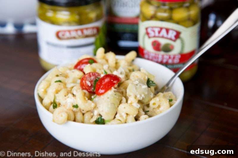 Sun-Kissed Mediterranean Pasta Salad 3 A bowl of Mediterranean pasta salad with a fork ready to be enjoyed