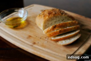 Rosemary Bread with Pass the Sushi 3 Rosemary bread sliced on a cutting board with olive oil in a bowl